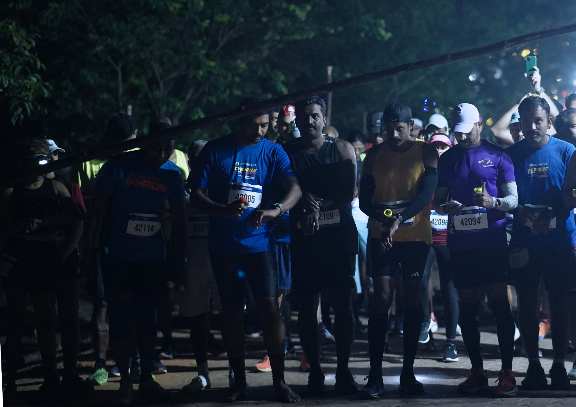 Marathon participants getting ready to start at dusk.
